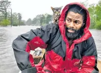  ??  ?? Robert Simmons and his kitten Survivor were rescued from New Bern, North Carolina, as Florence hit.