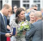  ??  ?? Top: Crowds welcome the royal couple to Gdansk. Above: William and Kate are presented with gifts during their visit to Poland.