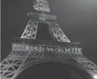  ?? MICHEL EULER / THE ASSOCIATED PRESS FILES ?? The Eiffel Tower is lit up in green Nov. 4, 2016, to mark the success of the Paris Agreement.