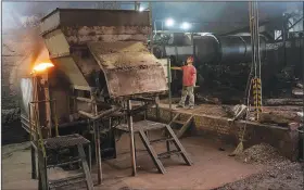  ?? ?? A worker operates an oven that dries yerba mate at the Andresito Cooperativ­e.