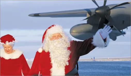  ?? AP PHOTO ?? This Dec. 5, 2017, photo shows Santa Claus and Mrs. Claus arriving at Saint Michael, Alaska, a remote island community off Alaska’s western coast. The Alaska National Guard visited the Bering Strait community as part of its annual Operation Santa...