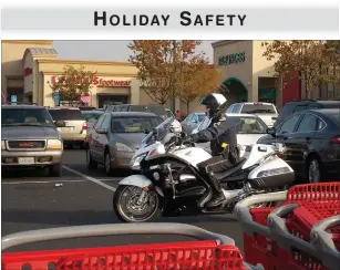  ?? RECORDER PHOTO BY RICK ELKINS ?? Portervill­e Police motorcycle Officer Carl Jordan patrols the parking lot of one of the city’s shopping centers on Wednesday. Police have stepped up patrols during the holiday season.