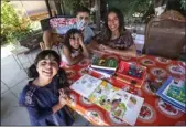  ?? MEL MELCON/LOS ANGELES TIMES ?? From left: Luna Tringale, 6, Anaya Tringale, 5, their father Rolando Tringale and mother Kamren Curiel study in their outdoor classroom, located in backyard of their home in El Sereno, on July 16.