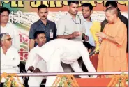  ?? PTI ?? Amanmani Tripathi touches Chief Minister Yogi Adityanath’s feet at a function in Gorakhpur on Saturday.