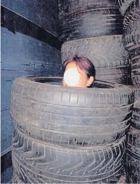  ??  ?? Distressed...one of the illegal immigrants was hiding in a stack of tyres