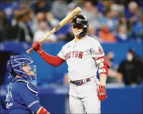  ?? Cole Burston / Getty Images ?? The Red Sox’s Enrique Hernandez taps himself on the head during his at-bat in the seventh inning against the Blue Jays on Thursday.