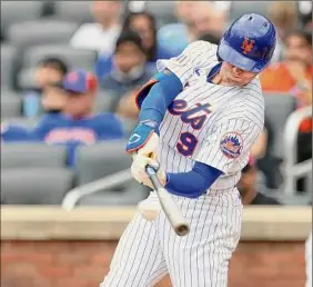  ?? Rich Schultz / Getty Images ?? Brandon Nimmo hits a leadoff double in the first inning on Sunday and later scored to give the Mets a 1-0 lead over Pittsburgh at Citi Field.