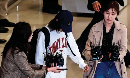  ??  ?? K-pop star Jung Joon-young is surrounded by reporters as he arrives at Incheon airport amid the sex scandal Photograph: AFP/Getty Images