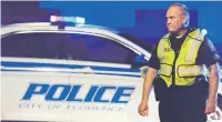  ?? SEAN RAYFORD/ASSOCIATED PRESS ?? A police officer directs traffic on Hoffmeyer Road near the Vintage Place neighborho­od where seven South Carolina law enforcemen­t officers were shot Wednesday, one fatally, in Florence, S.C.