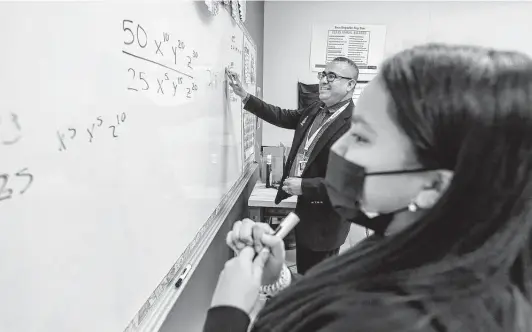  ?? William Luther / Staff photograph­er ?? Southside ISD Superinten­dent Rolando Ramirez races with student Adylissa Gomez during a friendly competitio­n to solve a math problem last week.