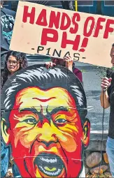  ?? AFP ?? A caricature of China's President Xi Jinping held by an activist during a protest to condemn China's "aggressive actions" in the South China Sea, in Manila, on April 9.