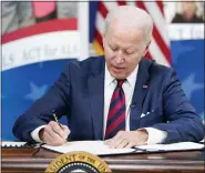  ?? PATRICK SEMANSKY — THE ASSOCIATED PRESS ?? President Joe Biden signs the “Accelerati­ng Access to Critical Therapies for ALS Act” into law during a ceremony in the South Court Auditorium on the White House campus in Washington on Thursday.