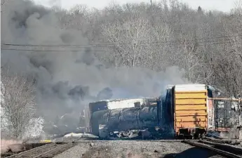  ?? Getty Images ?? Smoke rises from a derailed cargo train in East Palestine, Ohio, on Feb. 4