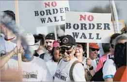  ?? ERIC GAY/AP ?? Texas border wall protest: Hundreds march along a Rio Grande levee Saturday to oppose the wall the U.S. government wants to build on the river dividing Texas and Mexico.