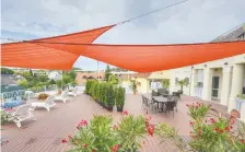  ?? CANSTOCK PHOTO ?? Shade sails like these offer an easy way to add protection from the sun and rain to your yard.