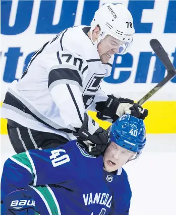  ?? DARRYL DYCK /THE CANADIAN PRESS ?? Los Angeles Kings forward Tanner Pearson checks Vancouver Canuck counterpar­t Elias Pettersson during the first period of their pre-season tilt at Rogers Arena on Thursday.