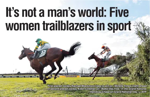  ??  ?? First placed Jockey Rachael Blackmore rides to win on “Minella Times” (left) ahead of second placed Jockey Aiden Coleman on “Balko Des Flos” in the Grand National
Hanidcap Chase on Grand National Day. — AFP