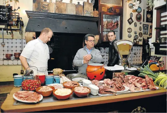  ??  ?? THE ROYAL ‘OUI’: Jean-Pierre Xiradakis, centre, in his kitchen at La Tupina in the historic centre of Bordeaux. When presidents or royals visit the region, this is where they eat