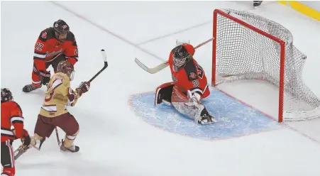  ?? STAFF PHOTOS BY MATT WEST ?? TWINE TICKLER: BC High’s Maverick Woods beats Pope Francis goalie Victor Larssen in overtime to give the Eagles another Super Eight state championsh­ip last night at the Garden.