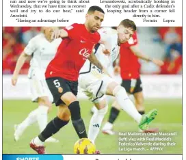  ?? – AFPPIX ?? Real Mallorca’s Omar Mascarell (left) vies with Real Madrid’s Federico Valverde during their La Liga match.