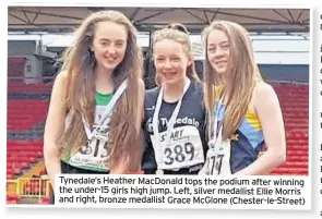  ??  ?? Tynedale’s Heather MacDonald tops the podium after winning the under-15 girls high jump. Left, silver medallist Ellie Morris and right, bronze medallist Grace McGlone (Chester-le-Street)