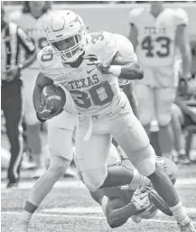  ?? Tom Reel / San Antonio Express-News ?? Texas running back Toneil Carter made a strong case for himself during the Longhorns’ annual Orange-White spring scrimmage.