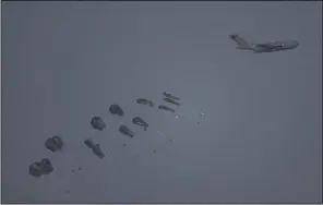  ?? (AP/Leo Correa) ?? An aircraft airdrops humanitari­an aid over northern Gaza Strip, as seen from southern Israel on Thursday.