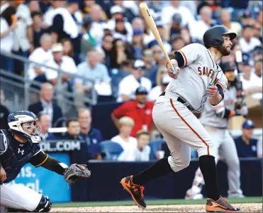  ?? Associated Press ?? The Giants' Brandon Belt watches his grand slam in front of San Diego Padres catcher Austin Hedges during the fifth inning of Friday’s game in San Diego