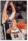  ?? (AP/Ron Jenkins) ?? Gonzaga forward Corey Kispert (24) drives inside as Virginia forward Sam Hauser (10) defends during the second half Saturday in Fort Worth. Kispert scored a career-high 32 points in Gonzaga’s 98-75 victory.