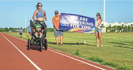  ?? PROVIDED BY KEITH SNODGRASS ?? Kaitlin Donner, 34, of Satellite Beach, Fla., owns the Guinness World Record for fastest 1-mile-run-while-pushing-a-stroller: 5 minutes, 11 seconds. Her 18-month-old son, Mikey, came along for the ride to glory.