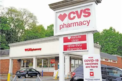  ?? AP PHOTO/GENE J. PUSKAR ?? Vehicles are parked in front of a CVS Pharmacy in Mount Lebanon, Pa., on May 3. CVS Health will close hundreds of drugstores over the next three years, the company said Thursday.