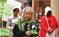  ?? (Dylan Martinez/Reuters) ?? AUTHOR MARGARET ATWOOD holds her new novel ‘The Testaments’ during the launch yesterday at a bookstore in London.