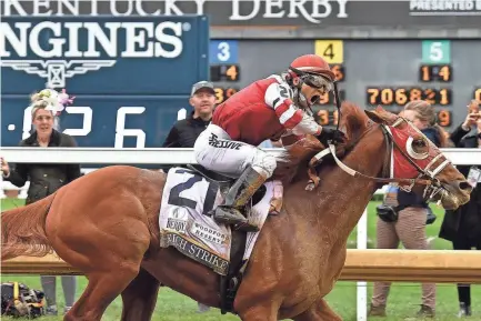  ?? TIMOTHY D. EASLEY/SPECIAL TO THE COURIER JOURNAL ?? Rich Strike, with Jockey Sonny Leon up, crosses the finish line to win the Kentucky Derby Saturday in Louisville Ky.