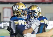  ?? PAUL CHIASSON/THE CANADIAN PRESS FILES ?? Winnipeg Blue Bombers running back Andrew Harris, left, with teammate Quincy McDuffie, has made a difference in the ground game.