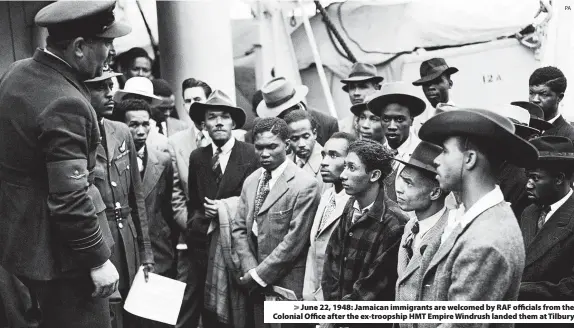  ?? PA ?? > June 22, 1948: Jamaican immigrants are welcomed by RAF officials from the Colonial Office after the ex-troopship HMT Empire Windrush landed them at Tilbury