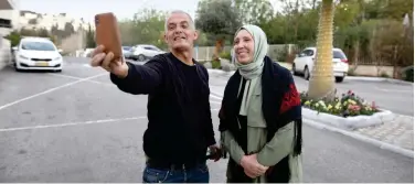  ?? Reuters ?? ↑
Iman Yassin Khatib (right) poses for a selfie in Nazareth on Thursday.