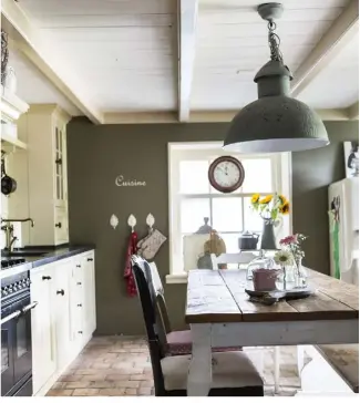  ??  ?? Left Old wooden caféstyle chairs add warmth to a grey kitchen