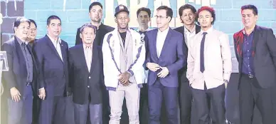  ??  ?? CJ Perez, center, the No. 1 draft pick, joins members of the Columbian Dyip, led by team governor Bobby Rosales, 4th left, and head coach Johnedel Cardel, right, during yesterday’s PBA Rookie Draft at Robinson’s Place in Ermita, Manila. Also onstage is PBA commission­er Willie Marcial, 3rd left. (Rio Leonelle Deluvio)