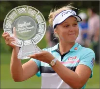  ?? Associated Press photo ?? Brooke Henderson poses with the trophy after winning the Meijer LPGA Classic golf tournament at Blythefiel­d Country Club June 18 in Grand Rapids, Mich.. Henderson is the winner of the Bobbie Rosenfeld Award for the second time in three years.