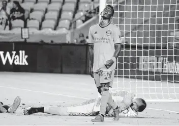  ?? Mark Mulligan / Staff photograph­er ?? The Dynamo’s Darwin Quintero laments a missed opportunit­y after Whitecaps goalkeeper Maxime Crepeau, bottom, stops a shot during the second half of Wednesday night’s defensive clash at BBVA Stadium.