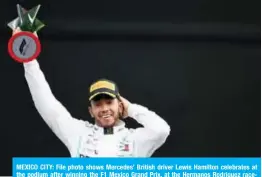  ??  ?? MEXICO CITY: File photo shows Mercedes’ British driver Lewis Hamilton celebrates at the podium after winning the F1 Mexico Grand Prix, at the Hermanos Rodriguez racetrack in Mexico City on October 27, 2019. —AFP