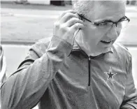  ?? Ronald W. Erdrich/The Abilene Reporter-News via AP ?? ■ Settling his earphones into place, Superinten­dent David Young prepares for his morning run Nov. 19. Thanks to a little bit of motivation, Young is 100 pounds lighter than at the start of 2018.