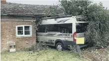  ??  ?? The minibus hit the house
