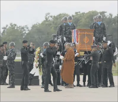  ??  ?? The body of Saman Gunan, the former Thai navy SEAL who died in the mission, is carried in a repatriati­on and religious rites ceremony.