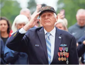  ?? MICHAEL CHOW/THE ARIZONA REPUBLIC ?? Steve Melnikoff salutes during a ceremony at the Normandy American Cemetery and Memorial on Tuesday.