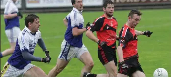  ??  ?? Kieran Butler launches a Bannow-Ballymitty attack with Richard Dunne of Ballyhogue in hot pursuit.