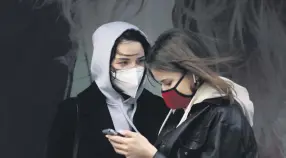  ??  ?? Women wearing masks talk in Times Square amid the coronaviru­s pandemic, New York City, April 9, 2020.