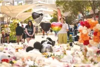  ?? Junction shopping center in Sydney on Saturday. (Jaimi Joy/Reuters) ?? FLORAL TRIBUTES commemorat­e six victims, five of them women, stabbed to death in the attack at Westfield Bondi