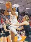  ?? AP PHOTO/BEN MCKEOWN ?? Tennessee’s Rickea Jackson shoots past Green Bay’s Natalie Andersen, right, on Saturday. Jackson led the Lady Vols with 26 points and nine rebounds.