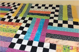  ?? SPECIAL TO THE EXAMINER ?? This checkerboa­rd rail fence quilt was made by an eleven year old at the summer learn to quilt classes organized by Yettie Ireland at St. Matthew’s/St. Aidan’s.